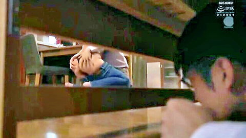 Voyeuristic Asian man in cap peeks through wooden slats at embarrassed woman covering her face in room