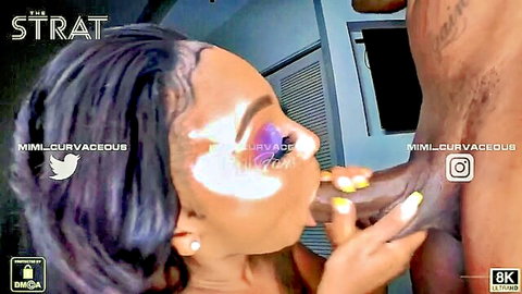 Ebony babe with purple hair and heavy makeup kisses huge black cock while stroking it