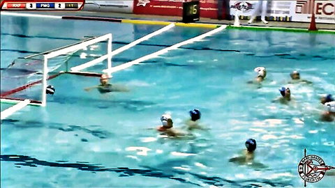 Athletic women in swimsuits playing intense water polo match