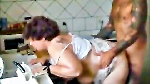 Curvy brunette bent over for doggy style penetration by tattooed man