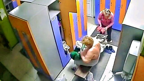 Chubby mature blonde with huge saggy tits sits topless in locker room wearing green boxing gloves