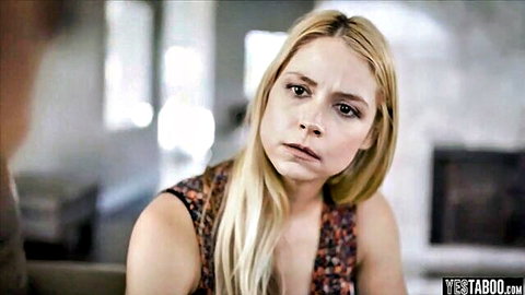 Surprised blonde in floral dress pouting in taboo living room scene with man behind