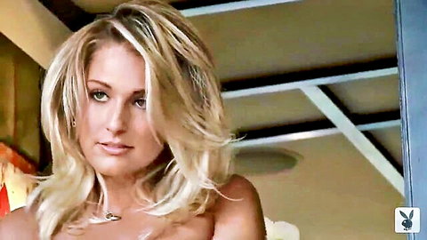 Blonde Playboy model with perfect tits exposed smiling seductively in close-up