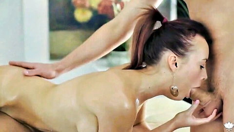 Kimberly nude and oiled, giving passionate blowjob during massage
