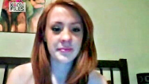 Redhead amateur with big tits flashing deep cleavage in low-cut top on webcam