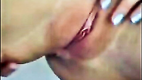 Mature fair-skinned woman spreads her pink wet pussy lips wide open with blue-nailed fingers