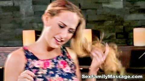 Blonde MILF in floral tank top smiles seductively during erotic family massage