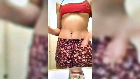 Amateur solo babe in bathroom posing in red halter top and shorts showing toned abs and navel piercing
