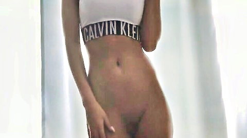 Ebony model strips to Calvin Klein bra, exposing her smooth pussy and curves