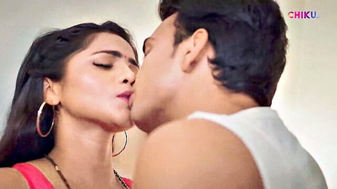 Desi Indian woman in red blouse passionately kissed on neck by shirtless man