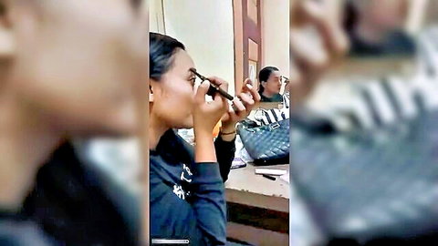 Two Asian women applying makeup, casual black tops, amateur cheating setup