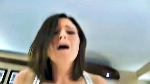 Brunette woman moaning intensely with teary eyes in white tank top, ready for creampie