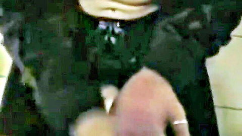 Brunette in black dress giving handjob in club toilet