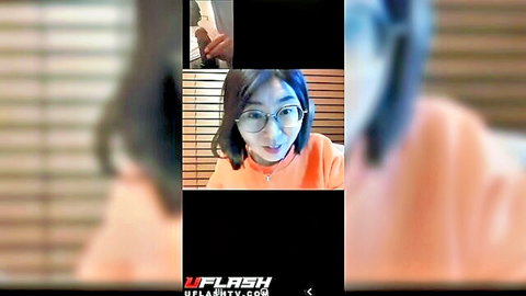 Nerdy Asian tutor with glasses in orange top on video call, BBC flash scene