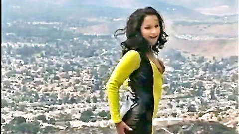 Sabina, hot ebony Swedish girl in sexy yellow black latex dress, posing with city view
