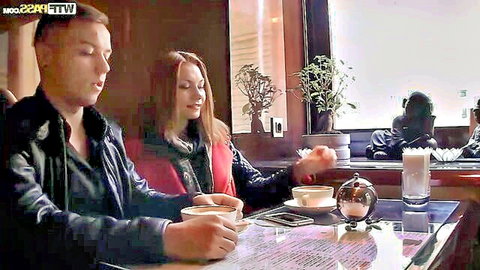 Young couple on a cozy first date sipping coffee in a cafe