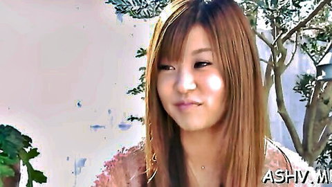 Ayumi Mochizuki smiling seductively outdoors in pink top