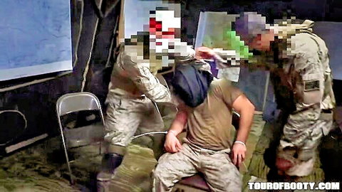 Camo soldiers surround handcuffed hooded prisoner in military tent interrogation