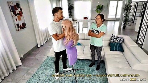 Shocked brunette MILF watches man grab pink-haired babe in purple dress from behind on couch