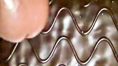 Close-up of pink nipple pressed against wavy chocolate cake icing in erotic food play
