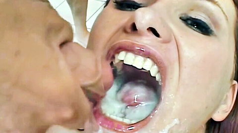 Close-up of redhead woman with open mouth full of cum, penis tip inside