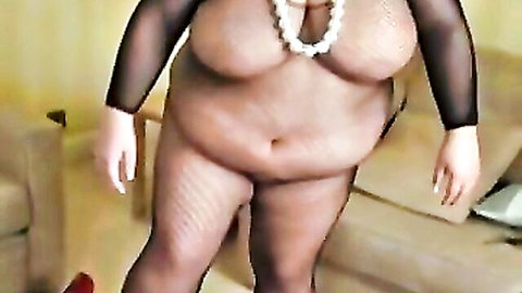 BBW mature woman exposing huge bare tits in sheer black top and fishnet stockings