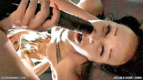 Zara deepthroating massive black dildo held by blonde Holly in double dose lesbian scene