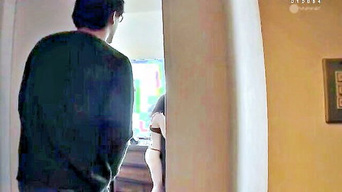 Busty blonde MILF exposes massive tits leaning forward as man watches from doorway