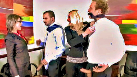 Velicity Von in steamy office scene with coworkers, seductive tie adjustment