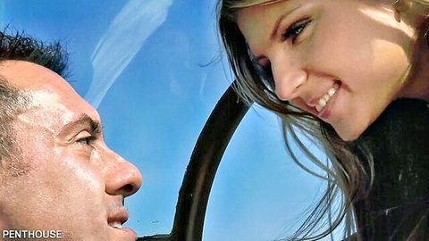 Gina Gerson smiling closely with man in helicopter cockpit