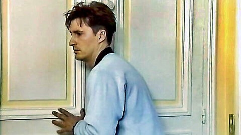 David Daniels in blue sweater, intense side profile pose
