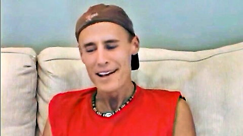 Kinky street walker in red tank top and cap smiles playfully