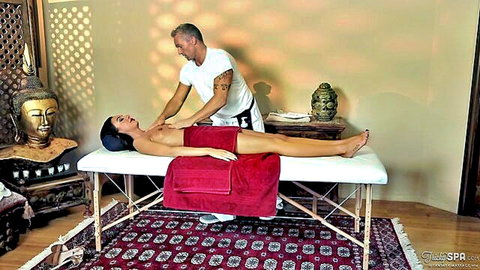 Tattooed masseur gropes skinny tanned brunette's small perky tits during nude spa massage