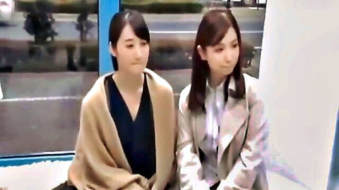 Two cute Japanese amateurs in coats sitting smiling side by side on a bus