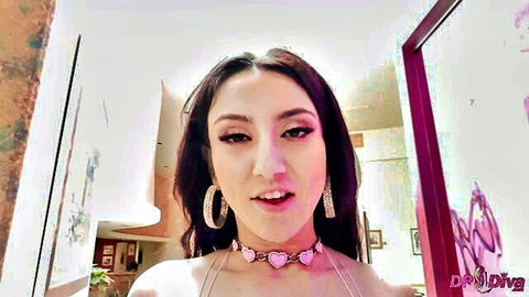 Sexy young brunette in pink heart choker and strappy lingerie pouting seductively