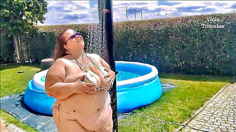 SSBBW in tiny wet bikini shower, water cascading over her curvy fat body outdoors