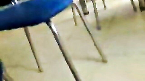 Blurry upskirt view under table showing legs and panties