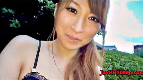 Asian woman in black lace bra outdoors, teasing smile in JAV style