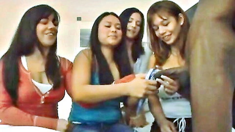 Four smiling Latinas pleasuring a black cock in group handjob scene