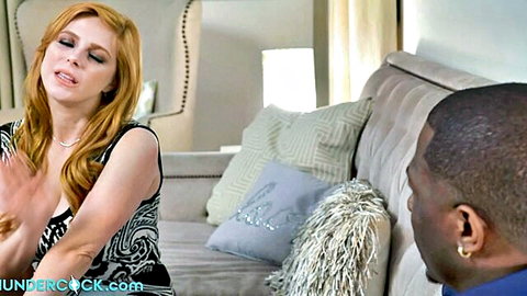 Penny Pax in black dress gestures to black boss on couch
