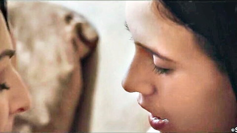 Two young brunette lesbians nuzzling noses intimately in close-up
