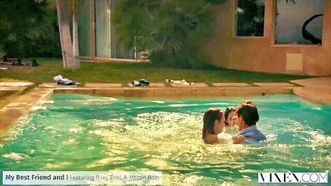 Brunette couple passionately kissing embrace in turquoise hotel pool water